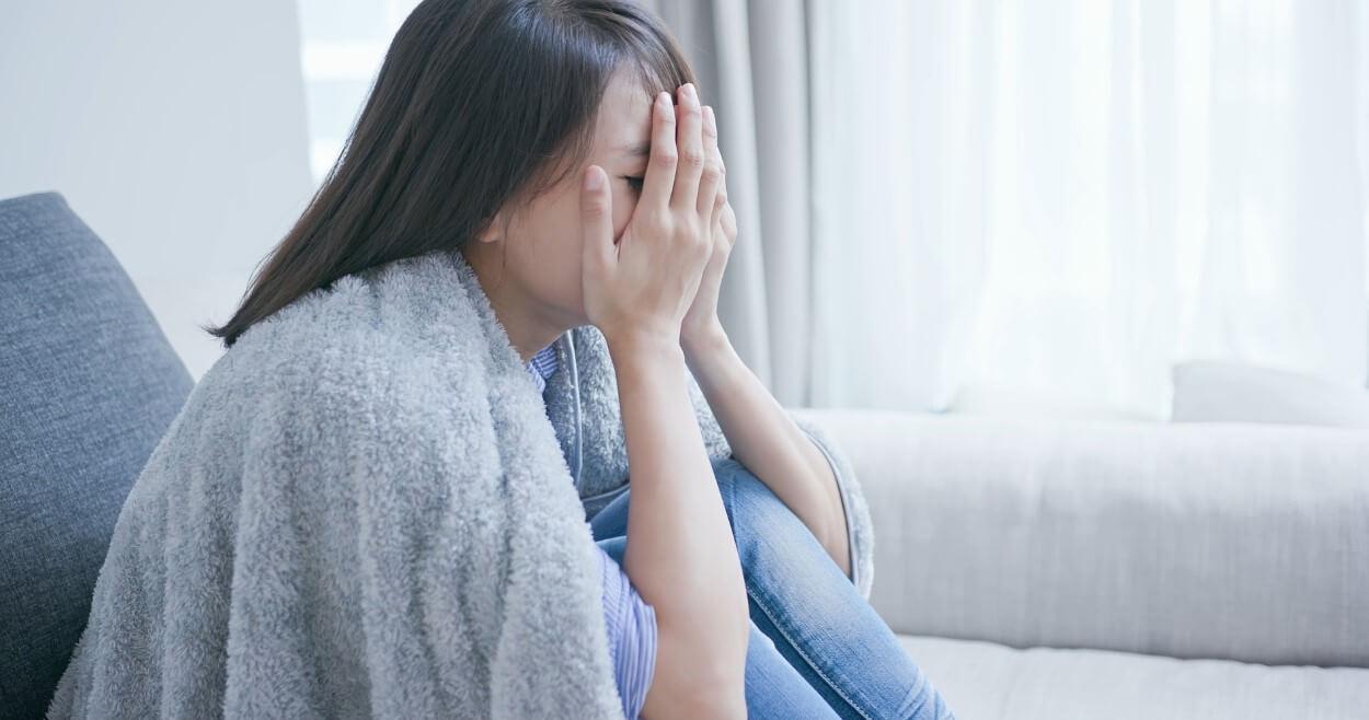体調不良の女性